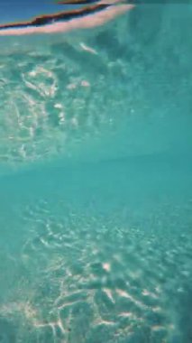 A vertical breathtaking underwater view of crashing waves