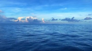 A pan over the sea to a sunlit horizon