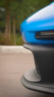 A vertical footage of Porsche GT3 4K Carrera 911 992 sports car exotic fast shark blue rolling video