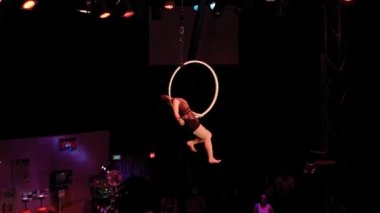 A female acrobat doing aerial acrobatics during the Phare Cambodian Circus performance, one of the popular tourist attraction in Siem reap