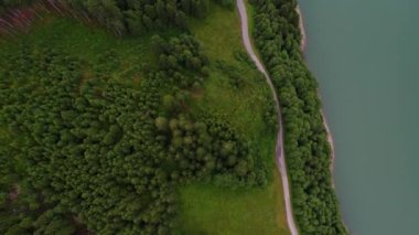 An aerial view of the Durlassboden reservoir in a green mountainous area in Austria