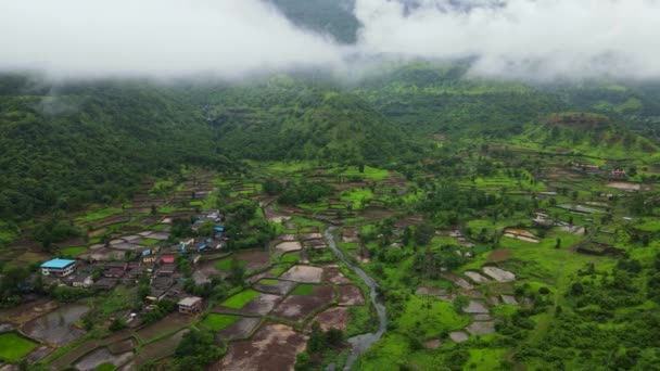 Aerial Shot Village Green Lands Forested Hills Covered Fog — Stockvideo