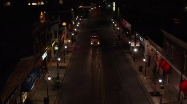 An aerial view of a truck on a road at night