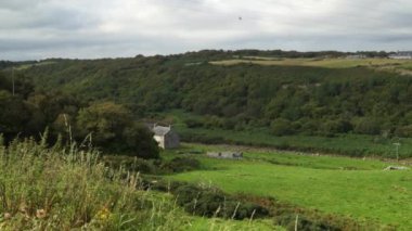 An old farmhouse in the beautiful valley of Dunbeath Strath, Scottish Highlands on a cloudy day