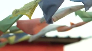 A colorful prayer flags on ropes waving in the air
