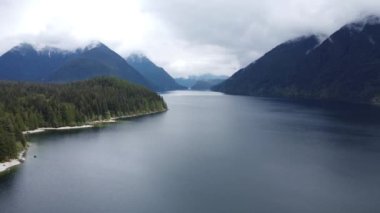A beautiful view of a lake near the mountains on a sunny day