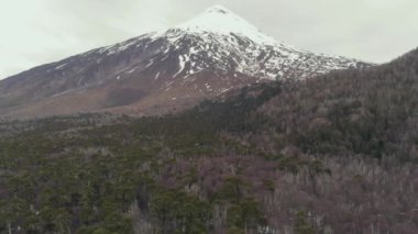 The volcan Quetrupillan covered with snow under gray clouds in Villarrica national park in Chile