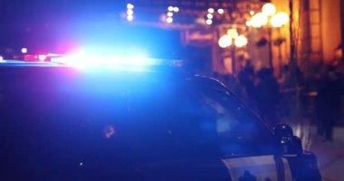 Police Ford Explorer with emergency strobe lights at night