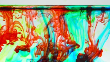 An abstract ink mix of vibrant colors in water on white background