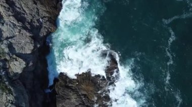 A bird's eye view of the waves crashing the rock at Tung Lung Chau village in Hong Kong