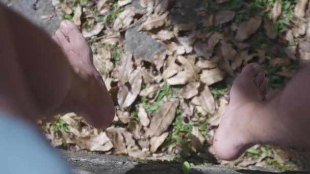 Высокий Угол Обзора Человека Размахивающего Ногами Земле Покрытой Сухими Опавшими — стоковое видео
