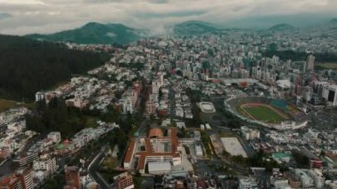 An aerial view of Quito city and Atahualpa stadium in Ecuador under a cloudy sky