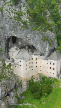 The vertical drone footage of Predjama Castle. Predjama, Slovenia.