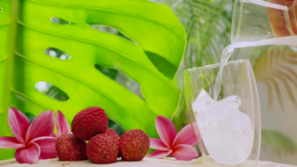 Male Hand Pouring Sparkling Water Glass Lychee Fruits Flowers Side — Αρχείο Βίντεο