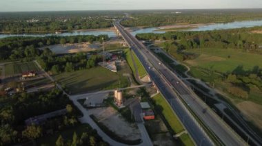 A drone footage of a bridge over the river on a cool spring daytime