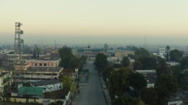 An aerial slow movement around Pakistan surrounded by buildings