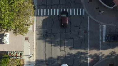 A top view of a traffic road with cars on a sunny day
