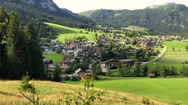 A countryside view surrounded by mountains