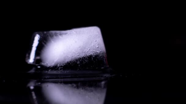 Close Time Lapse Ice Cube Melting Puddle Visible Reflection Isolated — Video Stock