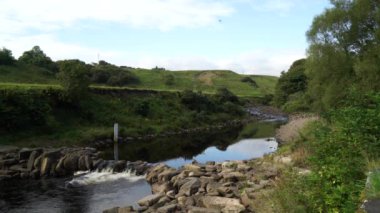 A scenic view of the weir on a flowing river in Dunbeath Strath, Scottish Highlands