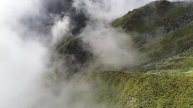 A low angle view of beautiful mountains near Madeira Island, Portugal on a foggy day