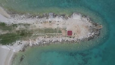 An aerial zooming-out view of the rocky coast of Pag island in Croatia