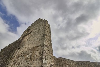 A low angle shot of the Ruins of the Lowenburg castle in Monreal Eifel in Germany with a gray cloudy sky