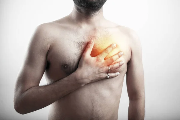 acid reflux, heart attack, chest pain, chest burn, man holding his chest inflammation area in white background