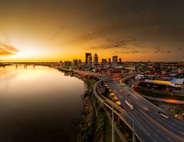 An aerial scene of night long exposure of a bridge over water with cars in Louisville, Kentucky, USA with a sunset sky clipart