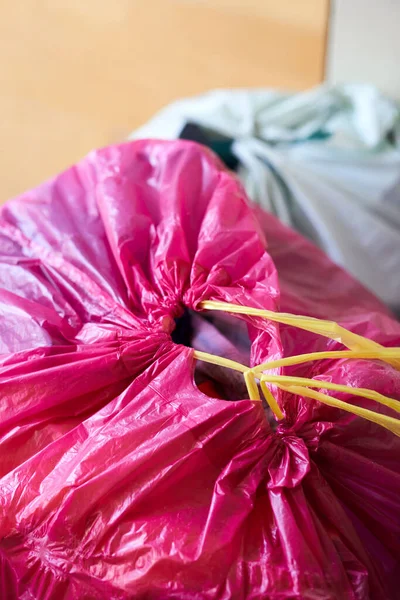a vertical shot of pink trash bag