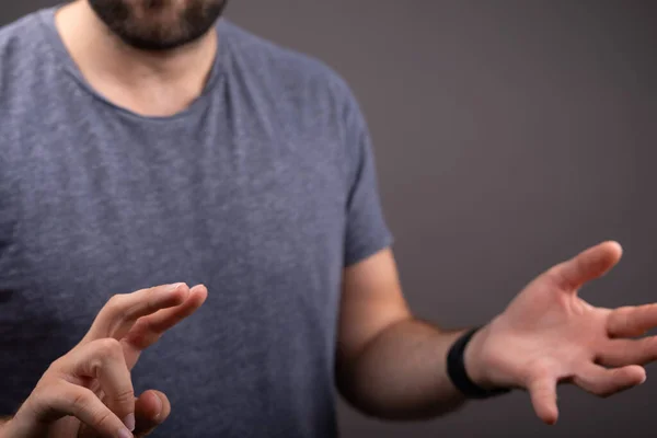 A closeup of a man showing hands