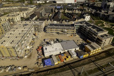 Bright aerial view of construction site in Zutphen of real estate investment and social housing market collective building project.