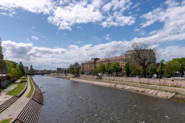 The flowing river under a bright blue sky in downtown Nis, Serbia