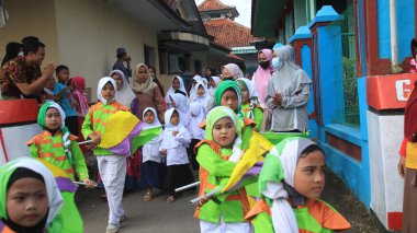 A children's marching band getting ready to perform in the streets of Indonesia