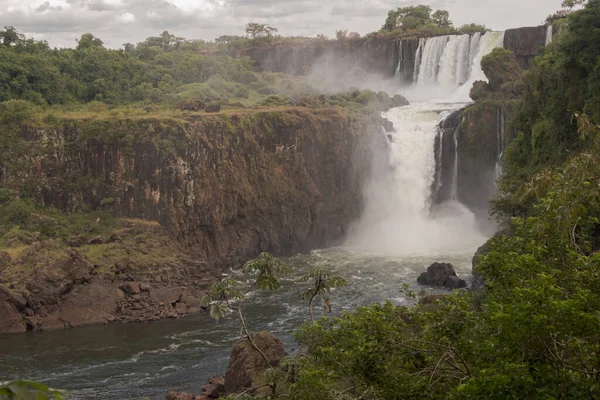 A beautiful landscape of a waterfall on a cloudy day