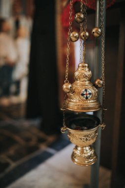 A closeup of a censer hanging in a church