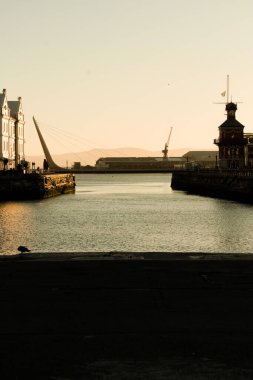 A beautiful shot of Waterfront Swingbridge, Marina in Cape Town, South Africa with sunset sky