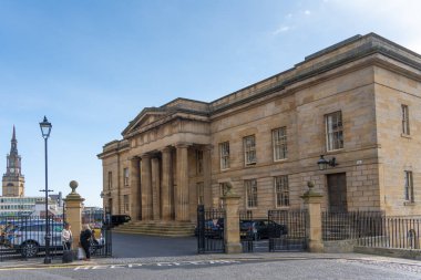 The Doric columns of the Moot Hall old court house, Newcastle upon Tyne, UK, with All Saints church spire in the rear view left.