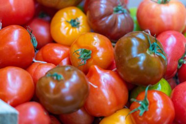 A closeup of red fresh cherry tomatoes in a market
