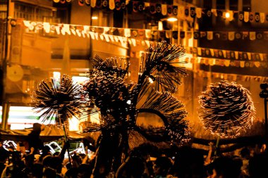 A beautiful view of people at the Tai Hang Fire Dragon Dance festival at night in Hong Kong