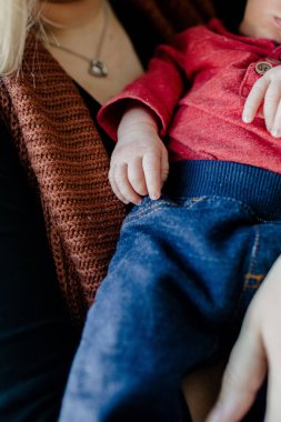 A vertical shot of a mother holding her baby