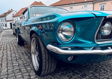 A closeup shot of the front view of a blue Ford mustang gt 390 fastbacks parked in a street in daylight in Samobor, Croatia