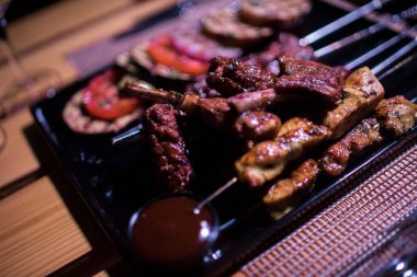 Bir tabak tavuk ve sığır barbeküsü yanında da bir bardak taze mojito.