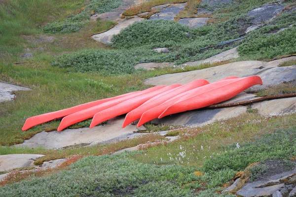 Red kayaks ashore in arctic landscape (horizontal), Ilulissat, Greenland