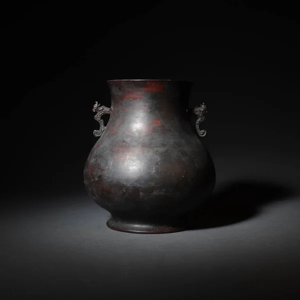 A closeup of an old jar in China isolated on a dark background