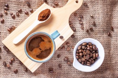 Amerikano manzarası ve tahtanın üzerinde kahve çekirdekleri.