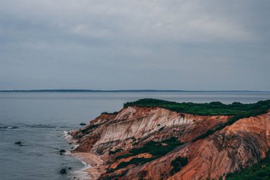 A beautiful view of rocky seashore under a cloudy sky