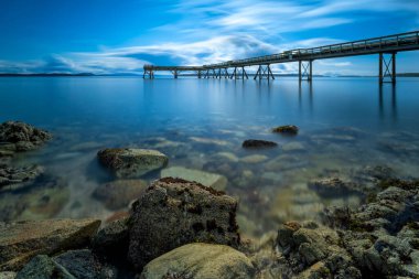 A long exposure of the Sidney Pier in the sea of BC, Canada at dusk clipart