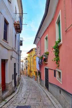 A vertical shot of a small street in Campobasso with residential buildings