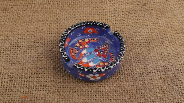 Closeup Beautiful Handmade Colorful Painted Ceramic Ashtray Fabric Texture Background — Stock Photo, Image